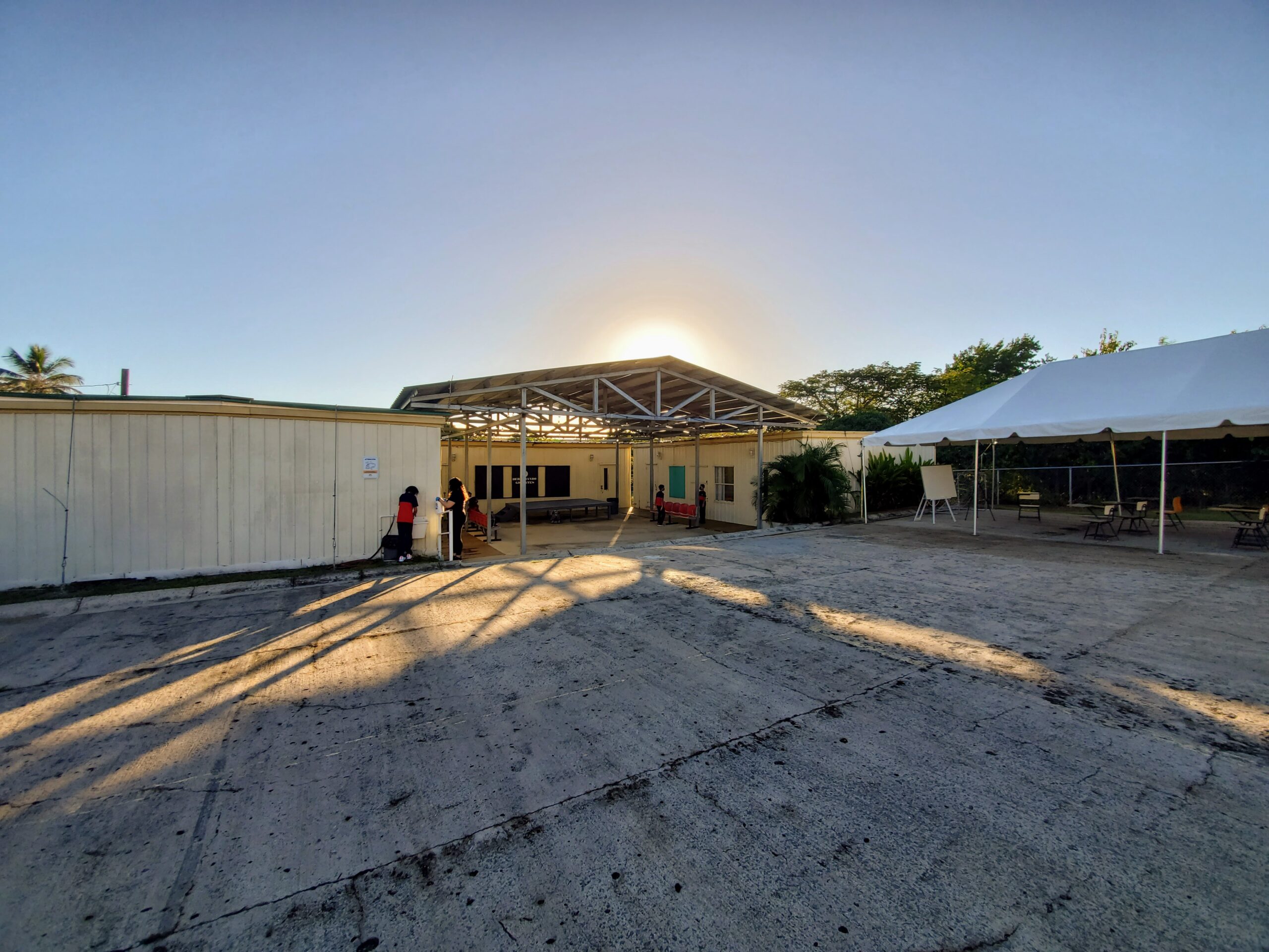 Three shipping containers and a tent comprise a school that needs repairs.