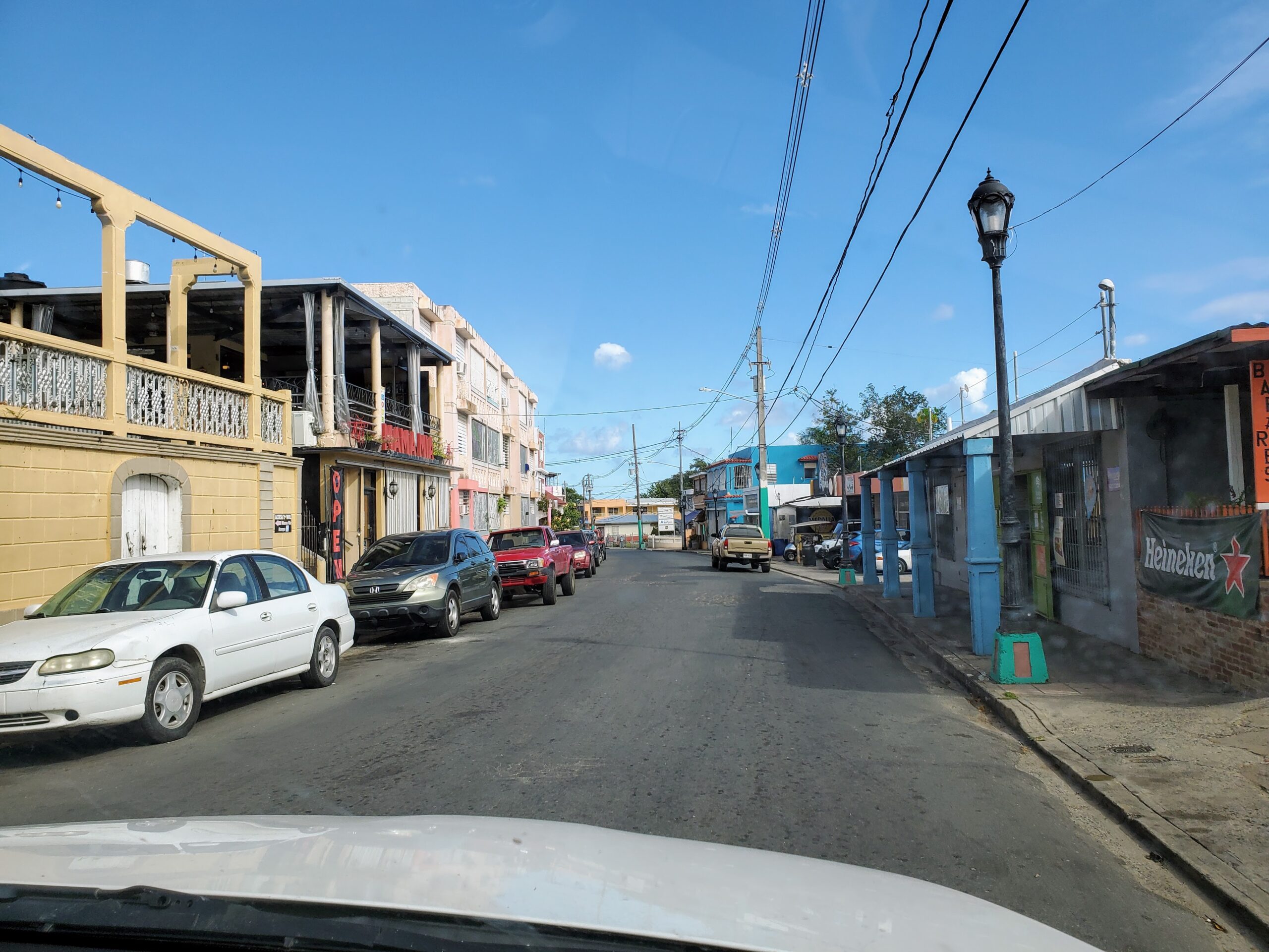 Vehicles travel along a narrow street.